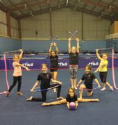Gymnasts posing in Aspire practice space